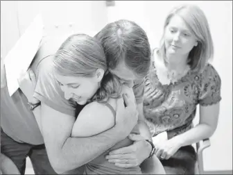  ?? Photos by Grant Halverson for USA TODAY ?? “These are the same tears (of joy) I cried the day you were born”: An emotional Ed Powers hugs his daughter Kristen after learning that she has tested negative for Huntington’s disease.