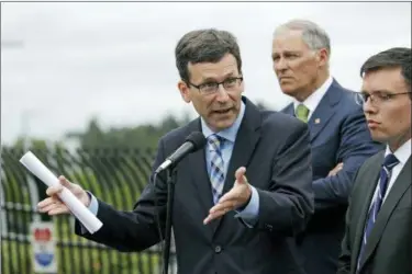  ?? ELAINE THOMPSON — ASSOCIATED PRESS FILE PHOTO ?? In this June 21, 2018, file photo, Washington state Attorney General Bob Ferguson, left, speaks as Washington Gov. Jay Inslee, center, and Solicitor General Noah Purcell look on at a news conference in SeaTac, Wash. Seven national fast-food chains have...