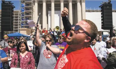  ?? Scott Heins / Getty Images ?? Oklahoma teachers rally in front of the state Capitol to demand pay raises and more school funding Wednesday.