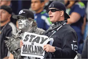  ?? JOE NICHOLSON, USA TODAY SPORTS ?? A Raiders fan urges his team to stay put during a Sept. 3 preseason game, but the Raiders, Chargers and Rams are exploring options to move to Los Angeles, possibly for the 2016 season.