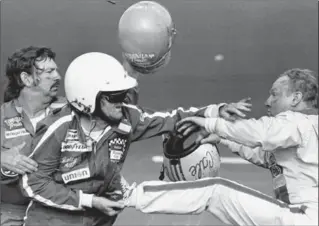  ?? RIC FELD, THE ASSOCIATED PRESS ?? In this Feb. 18, 1979 file photo, Bobby Allison holds race driver Cale Yarborough’s foot after Yarborough kicked him following an incident on the final lap of the Daytona 500.