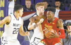  ?? PATRICK SEMANSKY/AP ?? Maryland forward Bruno Fernando, right, drives against Navy center Evan Wieck and guard Cam Davis (22) in the first half of their college basketball game at the Veterans Classic tournament in Annapolis on Friday.