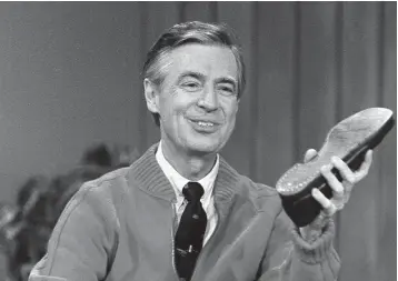  ?? Associated Press ?? ■ Fred Rogers rehearses the opening of his PBS show "Mister Rogers' Neighborho­od" during a taping in Pittsburgh. It’s been 50 years since Fred Rogers first appeared on our TVs, a gentle and avuncular man who warbled "Won't You Be My Neighbor?" The...