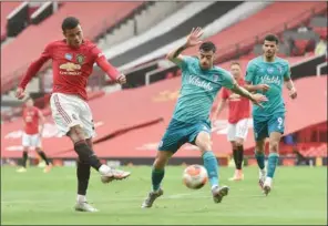  ?? (AFP) ?? Manchester United’s English striker Mason Greenwood (left) shoots to scores one of his two goals against Bournemout­h at Old Trafford in Manchester, England, on Saturday.