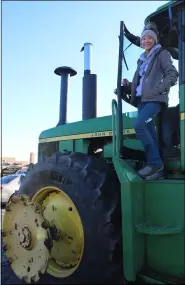  ??  ?? Firelands High School senior Liberty Gonia, 17, stands on top of the tractor she drove to school March 19.