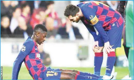  ??  ?? Ousmane Dembele (left) was consoled by Lionel Messi after injuring his thigh against Borussia Dortmund