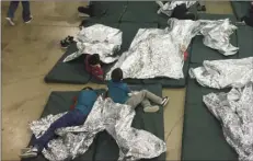  ??  ?? In this June 17 photo provided by U.S. Customs and Border Protection, people who have been taken into custody related to cases of illegal entry into the United States, rest in one of the cages at a facility in McAllen, Texas. U.S. CUSTOMS AND BORDER...