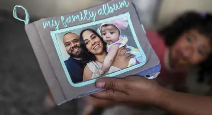  ?? Photos by Damian Dovarganes, The Associated Press ?? This book of photos that Guerra made for her daughter has a family photo with Rigo, Emilia’s late father, on the cover.