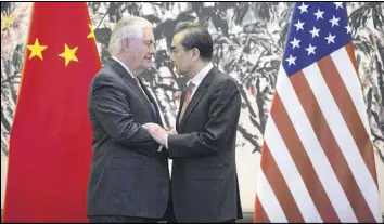  ?? AP ?? U.S. Secretary of State Rex Tillerson (left) and Chinese Foreign Minister Wang Yi met Saturday in Beijing. Tillerson pushed for closer China-U.S. cooperatio­n on dealing with North Korea’s nuclear program in talks with leading Chinese diplomats.