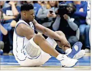  ?? AP - Gerry Broome ?? Zion Williamson, Duke’s freshman star, escaped serious injury after his shoe came apart early in Wednesday’s game against archrival North Carolina.