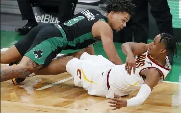  ?? MICHAEL DWYER — THE ASSOCIATED PRESS ?? The Celtics’ Carsen Edwards falls on Isaac Okoro while battling for a loose ball on Jan. 24in Boston.