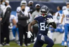  ?? BRETT CARLSEN - THE ASSOCIATED PRESS ?? FILE - In this Sunday, Dec. 20, 2020, file photo, Tennessee Titans wide receiver Corey Davis (84) runs with a touchdown reception against the Detroit Lions during the first quarter of an NFL football game, in Nashville, Tenn.