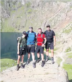  ??  ?? Triumphant quartet From left, friends Conel McKay, Alex Coyle, Drew’s dad Andrew Smith and Peter McKay take part in the Three Peaks Challenge for the Williams Syndrome Foundation