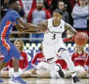  ?? MINCHILLO / ASSOCIATED PRESS JOHN ?? Cincinnati’s Justin Jenifer (3) drives against Savannah State’s Zach Sellers in the opener for both teams. Jenifer had 15 points and five assists in the Bearcats’ win.