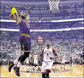  ?? NATHAN DENETTE / CANADIAN PRESS ?? Cleveland’s LeBron James, dunking over Serge Ibaka during his 35-point performanc­e, has reached the conference finals in seven straight years.