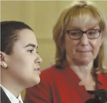  ?? STAFF PHOTOS BY PATRICK WHITTEMORE ?? ‘A BALANCING ACT’: Ella, above left, speaks to media in reference to a bill which would allow Massachuse­tts residents to designate their gender as ‘X’ on driver’s licenses and state IDs. cards. Ella lives in the district of Senate Ways and Means...