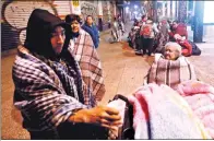  ?? EDGARD GARRIDO / REUTERS ?? Citizens huddle on a street in Mexico City after a massive earthquake rocked the nation on Friday.