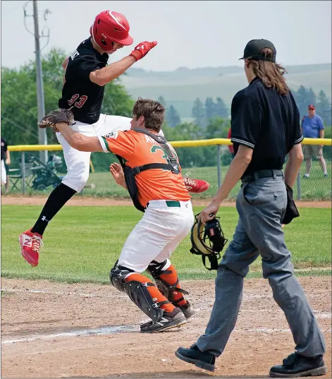  ?? STEVEN MAH/SOUTHWEST BOOSTER ?? Swift Current 18U AAA 57’s catcher Cash Arntsen (centre) applied the tag to a leaping Cole Breitkreuz during a 9-3 win for the host 57’s on Sunday.