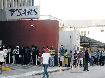  ?? /Fredlin Adriaan/The Herald ?? Compliance: Taxpayers queue outside the Western Cape head office of the South African Revenue Service in Long Street, Cape Town. The Davis tax committee recommends that lower corporate tax alone is not a sufficient incentive for investment.