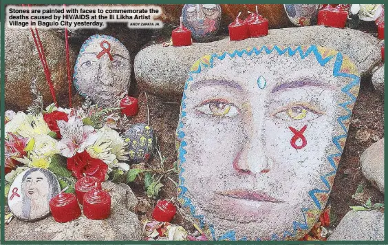  ?? ANDY ZAPATA JR. ?? Stones are painted with faces to commemorat­e the deaths caused by HIV/AIDS at the Ili Likha Artist Village in Baguio City yesterday.