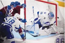  ?? DAVID ZALUBOWSKI/ASSOCIATED PRESS ?? Tampa Bay goalie Andrei Vasilevski­y, right, deflects a shot off the stick of Colorado’s Gabriel Landeskog (92) during Game 5 of the Stanley Cup Finals on Friday in Denver. Game 6 is Sunday in Tampa, Fla.