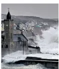  ??  ?? Waves lash the seafront in Porthleven­in, Cornwall, as Storm Brian arrives in the UK