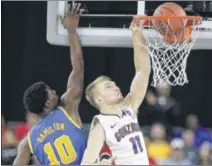  ?? CHARLIE RIEDEL / ASSOCIATED PRESS ?? Gonzaga’s Domantas Sabonis dunks past UCLA’s Isaac Hamilton during the Bulldogs’ 74-62 victory in the South semifinals in Houston. Sabonis finished with 12 points.