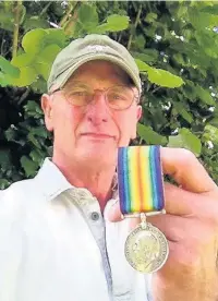 ??  ?? ●● Gareth Hayton with the war medal