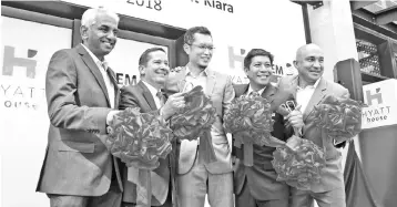  ??  ?? Hyatt Hotels &amp; Resorts regional vice president of Hyatt Place/Hyatt Houe &amp; Full Service Franchise Operations (Asia Pacific) Michael Koffler (second left), Anwar Syahrin (third left) and Peter (right) during the ribbon-cutting ceremony at the opening ceremony of Hyatt House Kuala Lumpur, Mont’Kiara.