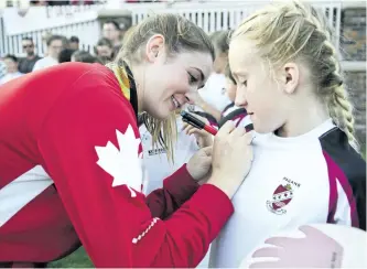  ?? JESSICA NYZNIK/EXAMINER ?? Olympic rugby player Hannah Darling signs Taya Sexsmith’s Peterborou­gh Pagans jersey at Nicholls Oval on Friday night. Darling, a former Peterborou­gh Pagan, was honoured at the rugby club Friday night. See additional coverage on Page D1 and see more photograph­s in the online gallery at www.thepeterbo­roughexami­ner.com.