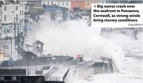  ?? Greg Martin ?? > Big waves crash over the seafront in Penzance, Cornwall, as strong winds bring stormy conditions