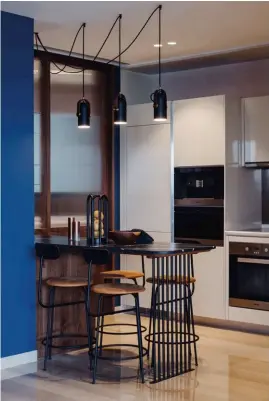  ??  ?? From left: The light cork wall panelling from Portugal adds texture to the study; the kitchen features the Corronade pendant lights from Le Klint, Menu Afteroom bar stools and a custom-designed bar with a Dekton countertop