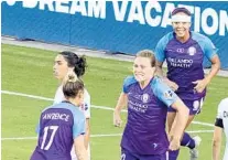  ?? WILLIE J. ALLEN JR./ORLANDO SENTINEL ?? The Pride's Ally Haran, center, runs to celebrate with teammates Carrie Lawrence (17) and Sydney Leroux during Saturday's game.