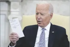  ?? EVAN VUCCI/AP ?? PRESIDENT JOE BIDEN HOLDS NOTES as he meets with Indian Prime Minister Narendra Modi in the Oval Office of the White House on Sept. 24, 2021, in Washington.