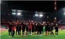  ??  ?? Bayer Leverkusen players salute an empty away end after winning 4-0 at local rivals Köln. Photograph: Wolfgang Rattay/ AFP/Getty Images