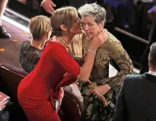  ?? — Reuters ?? Best Actress McDormand (right) receives a congratula­tory kiss from the Best Supporting Actress Janney.