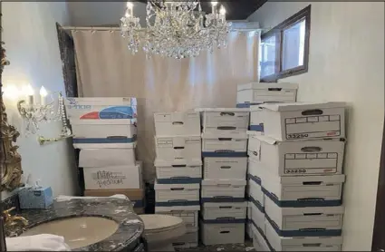  ?? JUSTICE DEPARTMENT VIA AP ?? This image, contained in the indictment against former President Donald Trump, shows boxes of records stored in a bathroom and shower in the Lake Room at Trump’s Mar-a-lago estate in Palm Beach, Fla. Doubts are mounting that the classified documents investigat­ion against Donald Trump can reach trial this year.