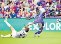  ?? ROY K. MILLER/ISI PHOTOS ?? Orlando Pride forward Chioma Ubogagu pushes the ball up the field while her jersey is grabbed by Sky Blue FC’s Erica Skroski on Saturday at Exploria Stadium.