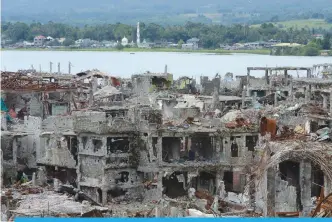  ?? —AFP ?? MARAWI: Photo shows bombed-out buildings inside the main battle area between government troops and ISinspired Muslim militants in Marawi.