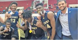  ?? DAVID FURONES/STAFF PHOTO ?? Six-foot-11 Elochukwu Eze, second from left, celebrates with teammates and coaches after Calvary Christian topped Tampa Catholic on March 4 in Lakeland to win Florida's Class 5A title. Eze spent last season coming off the bench but will start this...