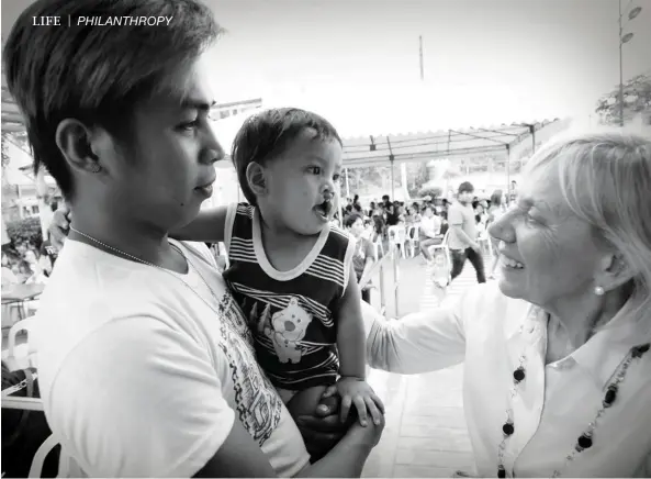  ??  ?? giving hope Kathleen Magee warmly greets an infant patient awaiting examinatio­n and treatment