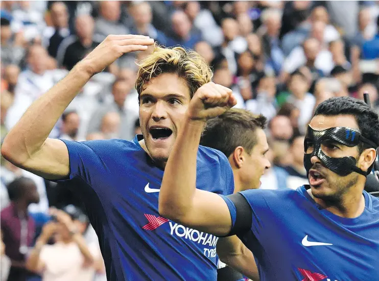  ?? — GETTY IMAGES ?? Chelsea’s Marcos Alonso, left, celebrates after scoring against Tottenham Hotspur on Sunday in London. Alonso had both goals in a 2-1 victory.