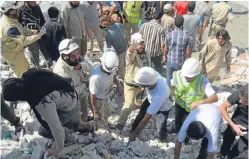  ??  ?? Left: Haian Dukhan at Kinkell Braes, St Andrews. Above: a rescue team search for victims after a Syrian regime attack in Ariha neighbourh­ood in Idib.