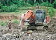  ?? GOH CHAI HIN / AGENCE FRANCE-PRESSE ?? An excavator digs into the ground at an illegal gold mine in West Tabir in Indonesia’s Sumatra. Many people in rural areas have been lured into working in the dirty and dangerous industry.