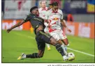  ?? AP PHOTO/MATTHIAS SCHRADER ?? Real Madrid’s Aurelien Tchouameni, left, fights for the ball with Leipzig’s Christophe­r Nkunku during the group F Champions League soccer match Oct. 25.