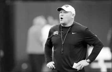  ?? STEVE MARCUS ?? UNLV coach Barry Odom calls out to players as they warm up for the UNLV Football Spring Showcase on Saturday at Allegiant Stadium. With the end of spring practices, Odom and his staff now turn their interest to the NCAA transfer portal.