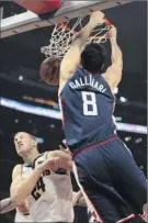  ?? Kyusung Gong / Associated Press ?? Clippers forward Danilo Gallinari dunks over Nuggets forward Mason Plumlee during their game in Los Angeles on Saturday.