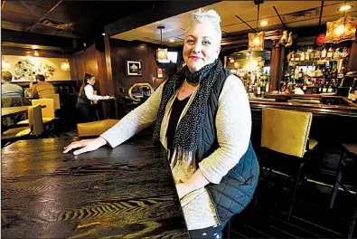  ?? NWA Democrat-Gazette/FLIP PUTTHOFF ?? Sharae Allen, seated at the The River Grille Steakhouse in Bentonvill­e, said she hopes to eventually return to work at the restaurant.