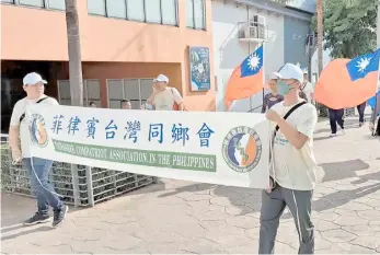  ?? PHOTOGRAPH COURTESY OF TECO ?? TAIWANESE community in the Philippine­s barreled through Manila streets in support for Taiwan’s participat­ion in the nearing WHA.