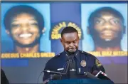  ?? AP/The Dallas Morning News/TOM FOX ?? Avery Moore, Dallas’ assistant police chief, holds a news conference Tuesday in front of a screen showing two of the suspects in the killing of Joshua Brown.